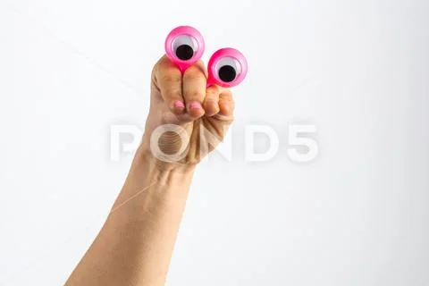 Funny character creature looking skeptical depicted with female hand and goog Stock Photos