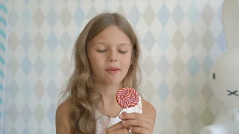 Funny child with candy lollipop, happy little girl eating lollipop, kid eat Stock Footage 93825694
