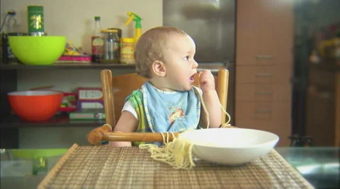 Funny child playing with spaghetti and sauce. Scene 3 Stock Footage 44561992