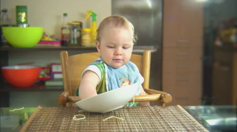 Funny child playing with spaghetti and sauce. Scene 4 Stock Footage 44562003