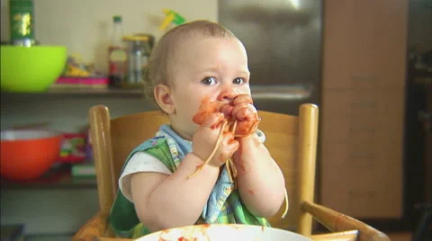 Funny child playing with spaghetti and sauce. Scene 6 Stock Footage 44562029