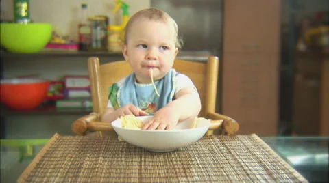Funny child playing with spaghetti and sauce. Scene 1 Stock Footage 44562715