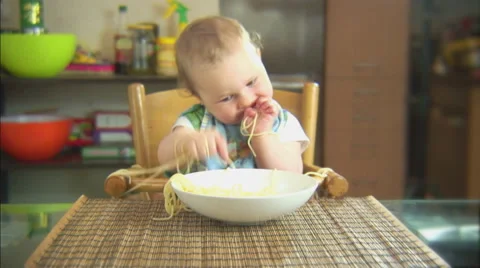 Funny child playing with spaghetti and sauce. Scene 2 Stock Footage 44562736
