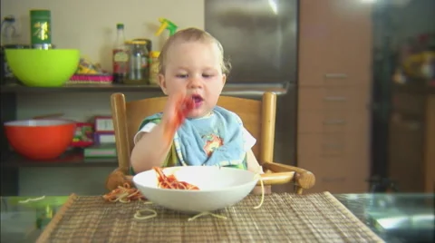 Funny child playing with spaghetti and sauce. Scene 5 Stock Footage 44562747