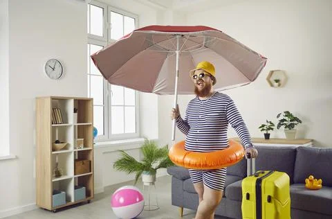 Funny chubby young man spending his summer vacation at home during Covid Stock Photos