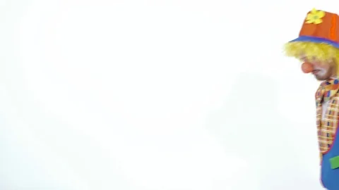 Funny clown passing by the camera stops to make a surprise Stockbeeldmateriaal 70286284