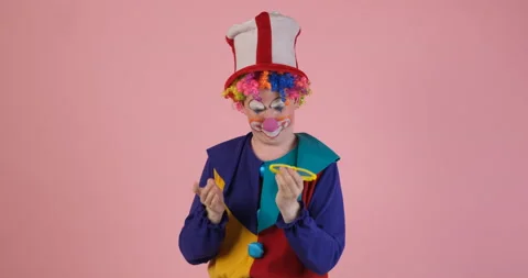 Funny clown selecting multicolored glasses Video stock 155107667