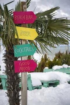 Funny colorful pointer to a beach bar on a snowy tropical beach Stock Photos
