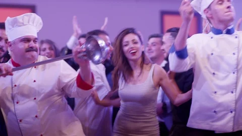 Funny cook chef in white uniform having fun dance at a colorful party . Stock Footage 123730241