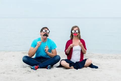 Funny couple on a beach Stock Photos