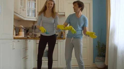 Funny couple dancing in the kitchen Stock Footage 131080232
