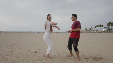 Funny couple dancing on the sand beach Stock Footage 235423707