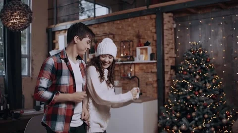 Funny couple having fun at home in the living room near the Christmas tree. Stock Footage 142942559