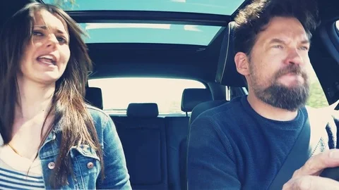 Funny couple singing and dancing in car 4K retro style Stock Footage