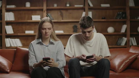 Funny couple using mobile phone and then taking on tin foil helmet because of 5G Stock-Footage 146707165