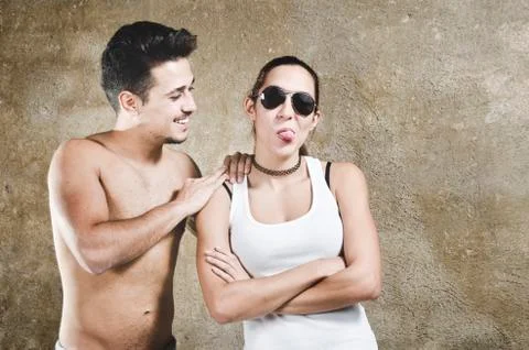 Funny couple on wall background Stock Photos