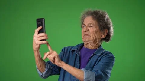 Funny crazy happy elderly old toothless woman taking selfie using mobile cell Stock Photos