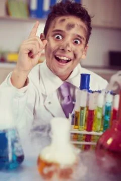 Funny crazy scientist boy working in a laboratory Stock Photos
