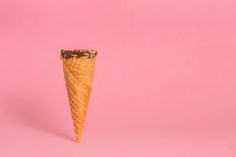 Funny creative concept of close up empty wafer cone with chocolate glaze and  Stock Photos