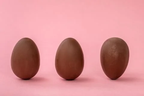Funny creative concept of Easter eggs on pink background, copy space Stock Photos
