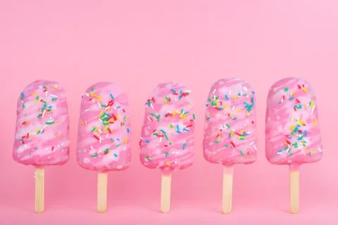 Funny creative concept of unstable standing popsicle covered sprinkles on pin 스톡 사진