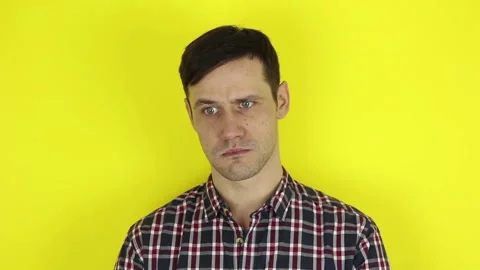 A funny, cute guy is actively playing with a purple balloon. Stock Footage 127645424