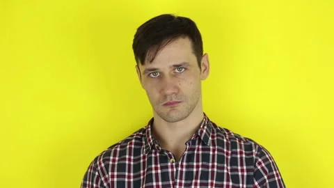 A funny, cute guy is actively playing with a purple balloon. Stock Footage 127645618