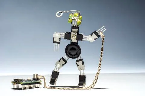 The funny, cute robot from microcircuits and transistors keeps a board on a c Stock Photos