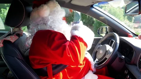 Funny cute Santa Claus driving car dancing Stock Footage