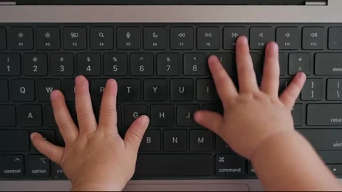 Funny cute top shot view on small baby hands typing on laptop computer keyboard 스톡 동영상 342619415