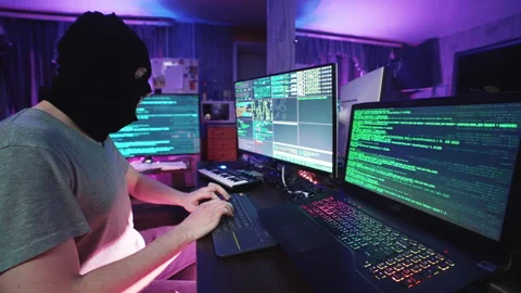 Funny cyber hacker coding on computer or man in mask hacking program on laptop 動画素材 256885907