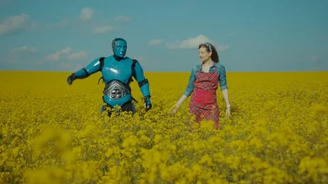 Funny cyborg android robot dancing in couple with young cheerful pretty woman Stock Footage 133297021