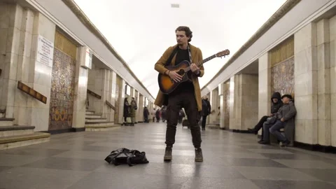 Funny dance of cool man with old guitar in the old subway station Stock Footage 151329467