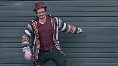 Funny dancer in hat, glasses and hip sweater having fun outdoors. Guy dancing Stock Footage 273134383