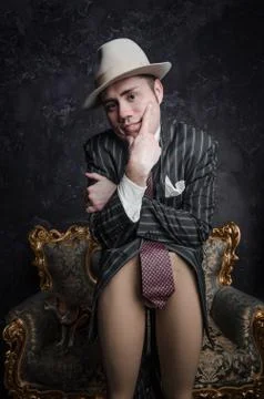 Funny detective in big hat leaned his elbows on bottom bared part of dummy. He Stock Photos