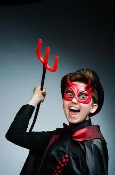 Funny devil against dark background Stock Photos