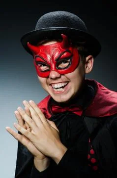 Funny devil against dark background Stock Photos