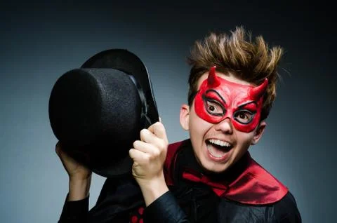 Funny devil against dark background Stock Photos