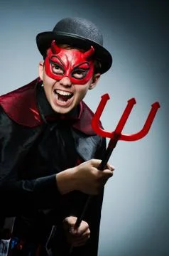 Funny devil against dark background Stock Photos