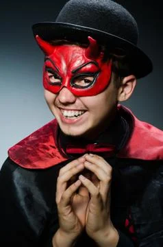 Funny devil against dark background Stock Photos