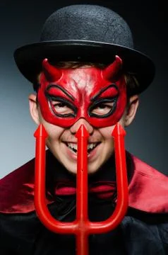 Funny devil against dark background Stock Photos