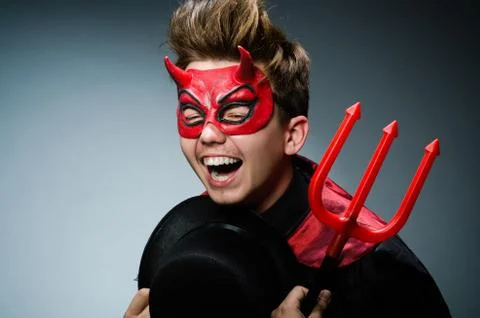 Funny devil against dark background Stock Photos