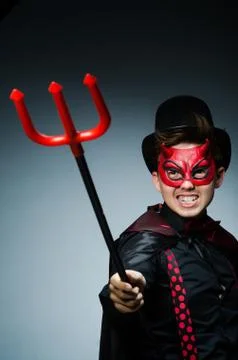 Funny devil against dark background Stock Photos