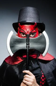 Funny devil against dark background Stock Photos