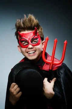 Funny devil against dark background Stock Photos