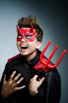 Funny devil against dark background Stock Photos