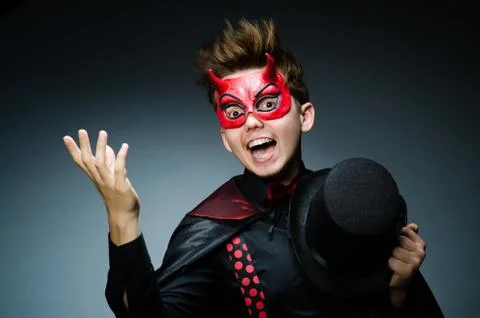 Funny devil against dark background Stock Photos