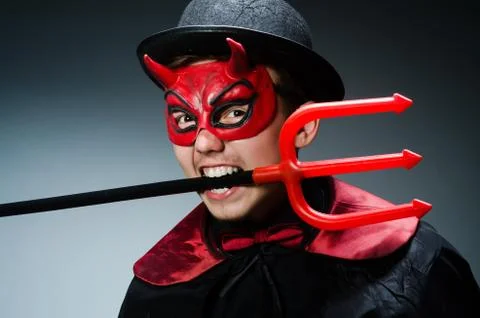 Funny devil against dark background Stock Photos