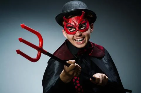 Funny devil against dark background Stock Photos