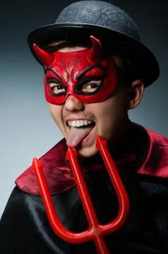 Funny devil against dark background Stock Photos